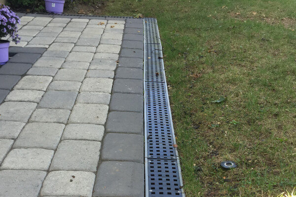 Track Drain Installation along Paver Walkway